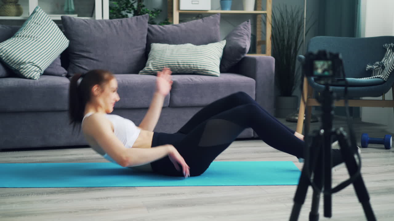Woman doing crunches at home workout video