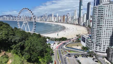 beach scene at camboriu in santa catarina brazil. beach landscape. landmark ferris wheel. highrise buildings. beach scene at camboriu in santa catarina brazil.