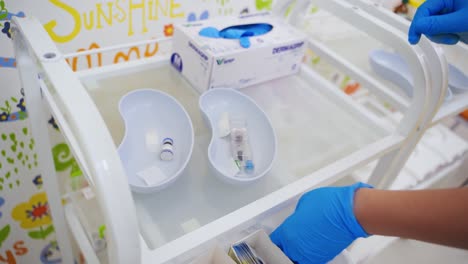 doctor prepares medical instruments. hands in blue gloves of a nurse preparing syringe for injection in clinic. medical concept.