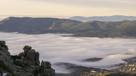 rocky mountain ridge over clouds