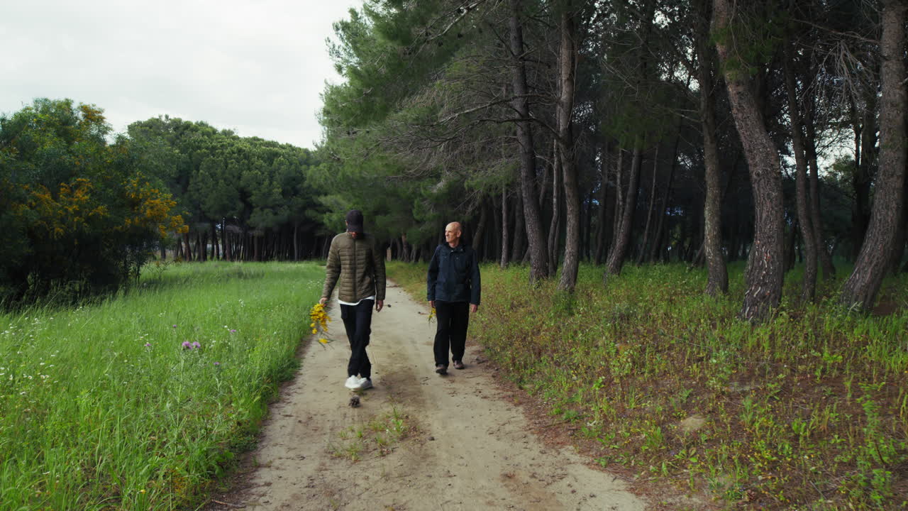 Two Men Walking Along a Country Path for a Picnic