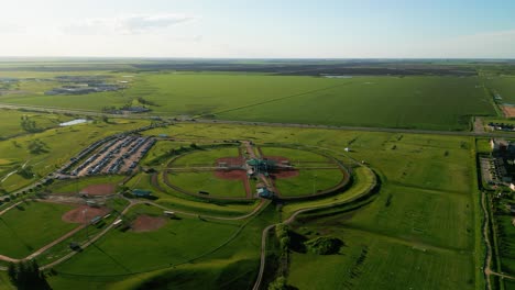 sunset drone orbit on sports complex people playing on an outdoor soccer field park in the countryside of winnipeg manitoba canada