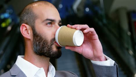 businessman having coffee from disposable cup