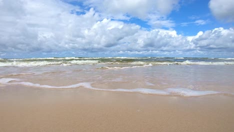 gentle waves on sandy beach of baltic sea coast in poland