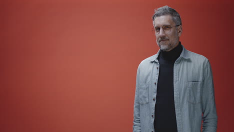middle-aged man in a denim shirt and black turtleneck