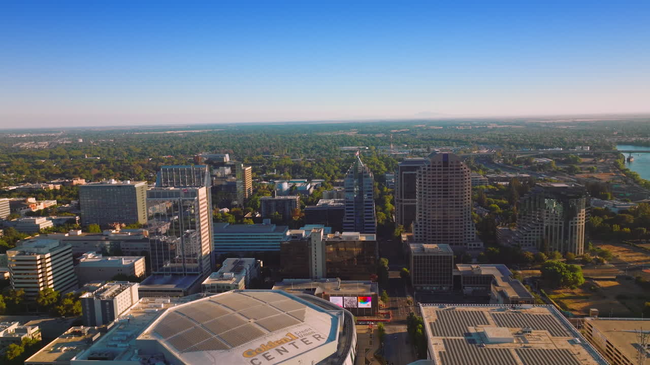 Rising over the beautiful capital of California State on bright sunny day. Modern buildings of Sacramento at the backdrop of clear blue sky.