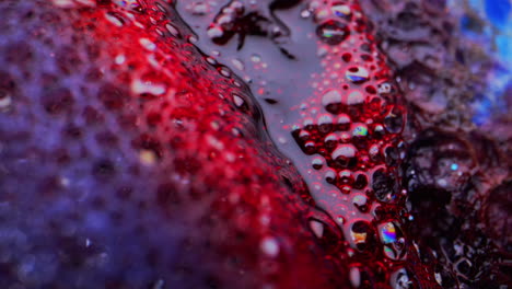 abstract macro photography of red and purple liquid with bubbles