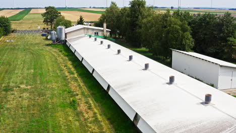 chicken farm roofed with vents in the farm. - aerial shot
