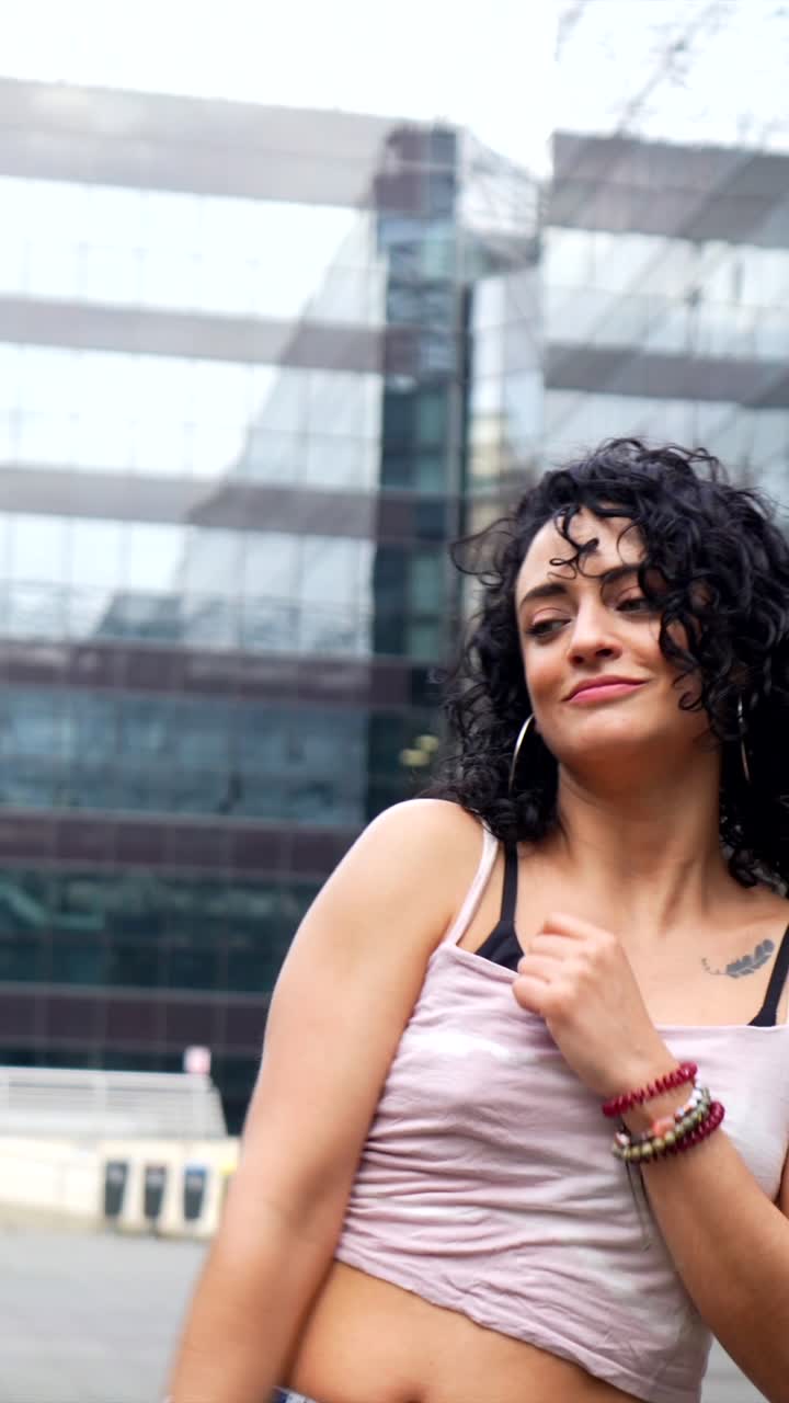 Woman with curly hair in an urban setting