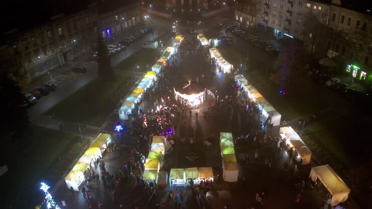 Drone view of Christmas stalls and carousel on the Podgorski Square with St