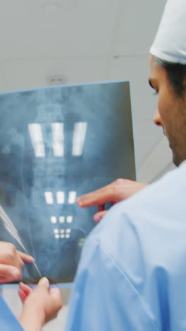 surgeon and colleague discussing over an x-ray