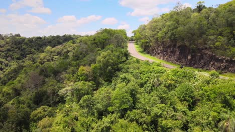 a road winding through the jungle on a south american mountain, offering an adventurous journey through the lush wilderness and mountainous terrain