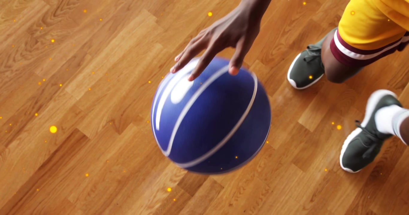 Steadying ball with right hand causing dribble and refining control by teenager in sports on court