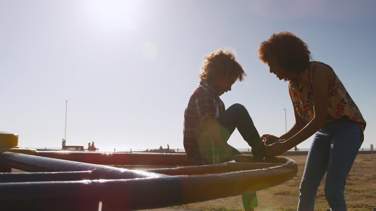 Mother and son having fun at playground