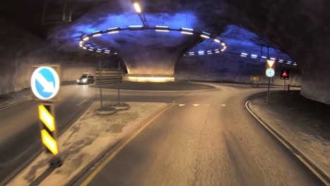 butunnel is a three-armed tunnel in norway. inside the tunnel is a roundabout. car rides through the tunnel point-of-view driving