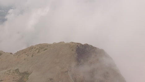 clouds and weather near the summit of a mountain as a drone flies overhead