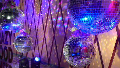 the four purple disco balls rotate. the symbol of 80s and 90s party time