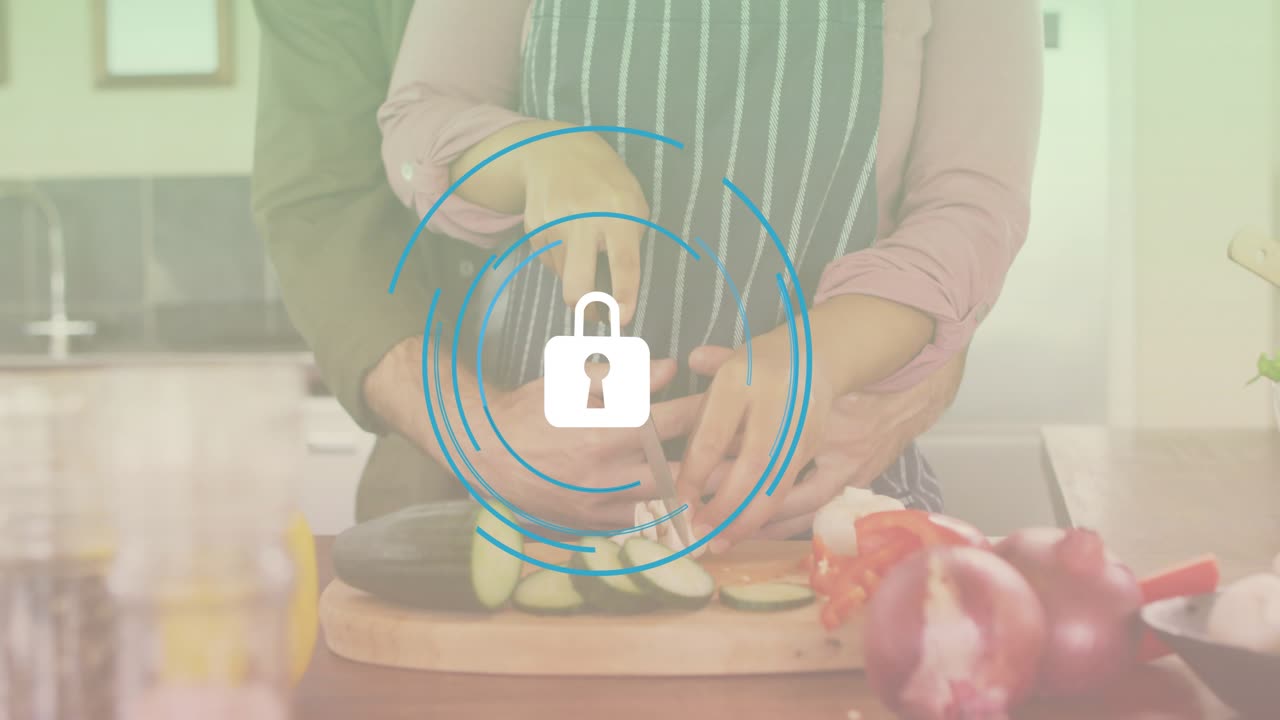Woman slicing eggplant at kitchen counter triggers partner guiding knife motion for cooking lesson