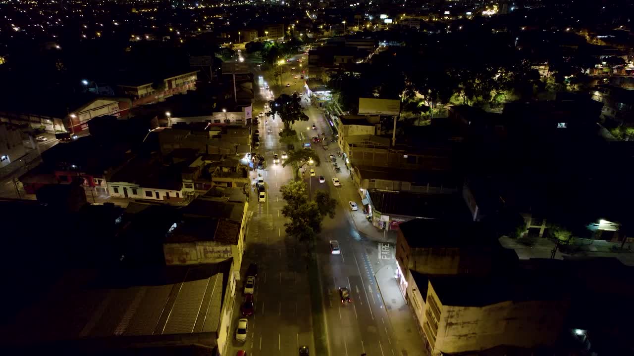 Aerial drone footage of Cali Valle del Cauca Colombia at night showing illuminated cityscape and urban skyline