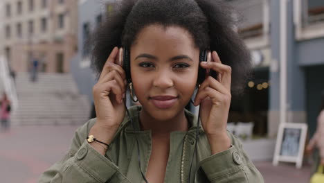 slow motion portrait of young trendy african american woman wearing headphones listening to music
