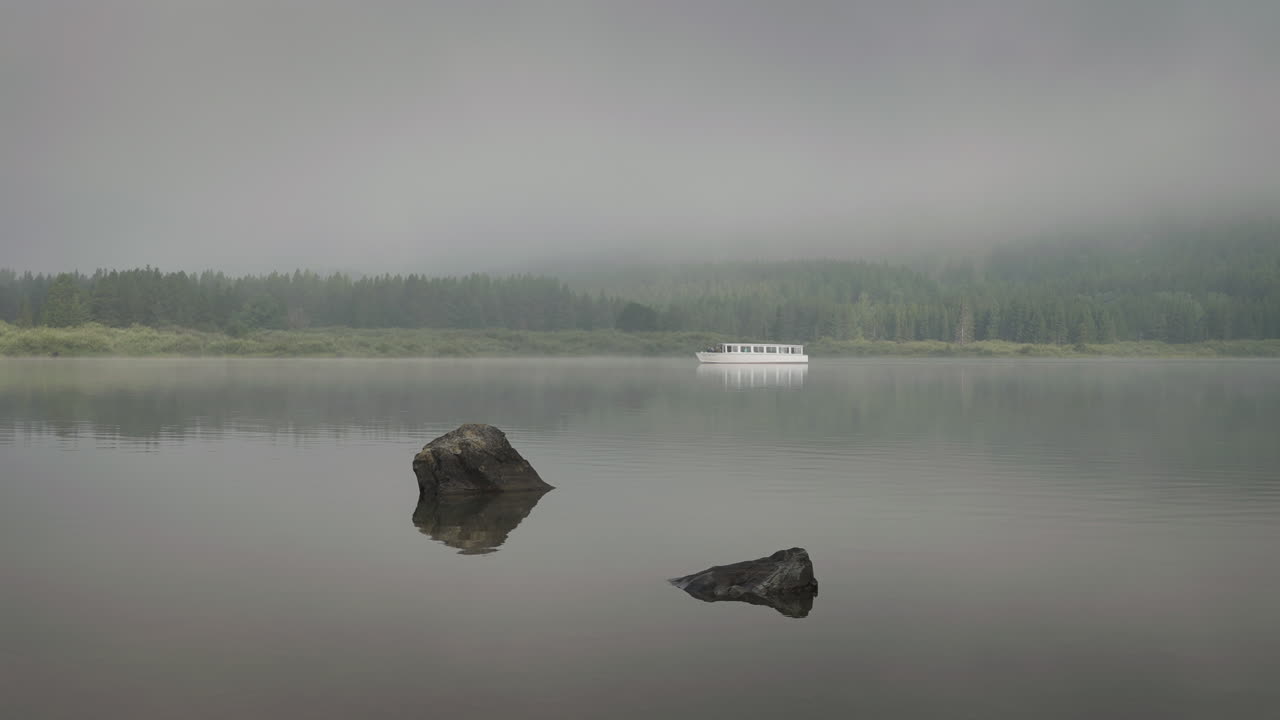 Misty Montana lake with a boat, calming and serene natural scenery