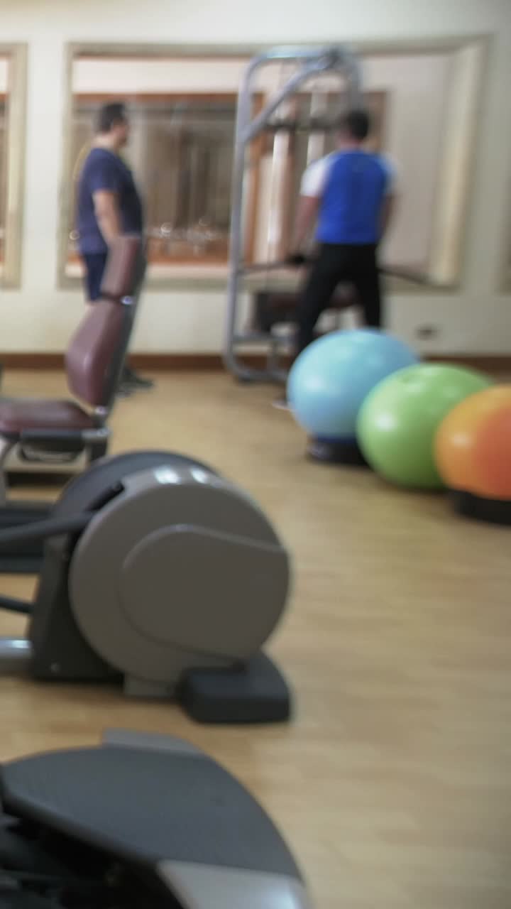 Gym with exercise equipment and people