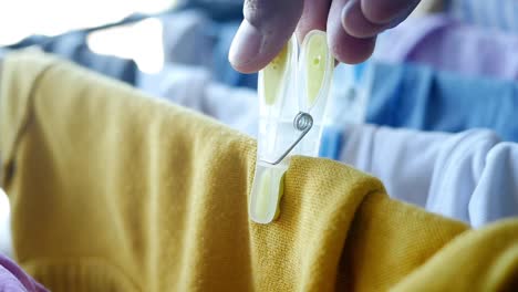 close up of yellow clothes peg on a clothesline