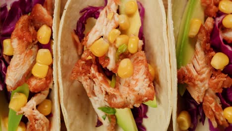 chicken tacos with corn, avocado, and red cabbage