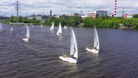 sailing competition on a river near industrial area