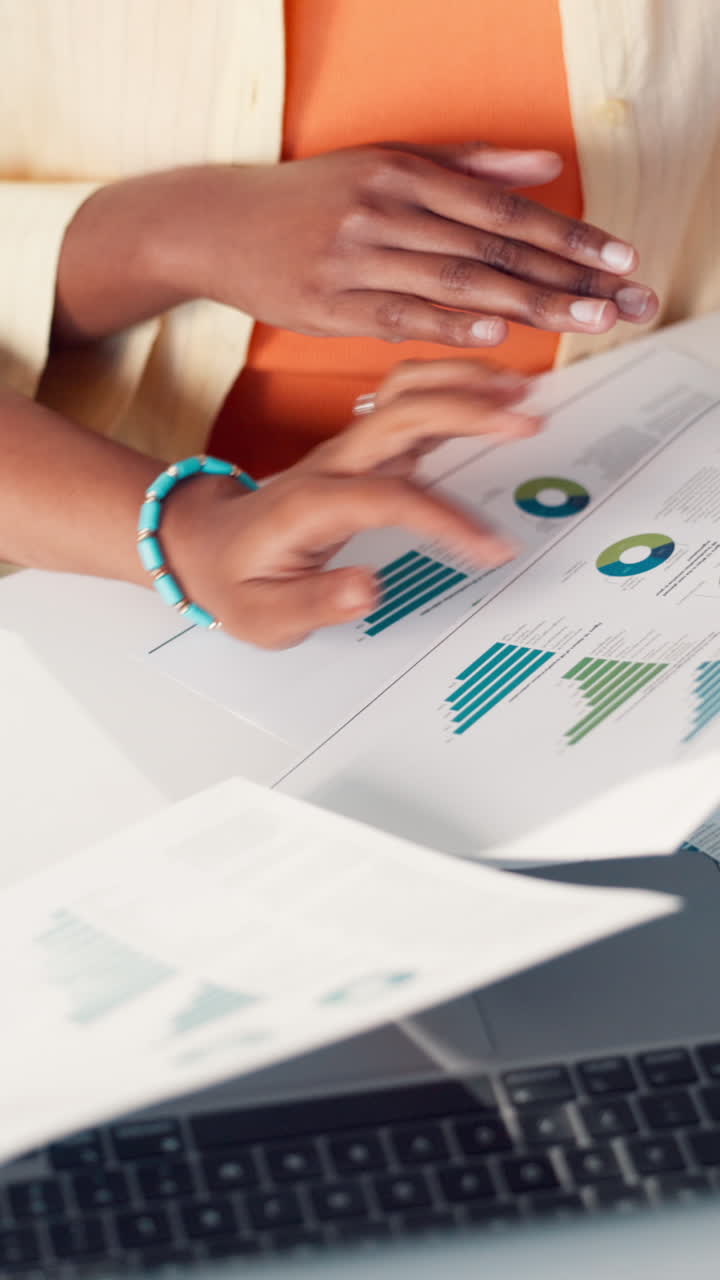 Close-up of Hands Pointing at Business Charts and Documents