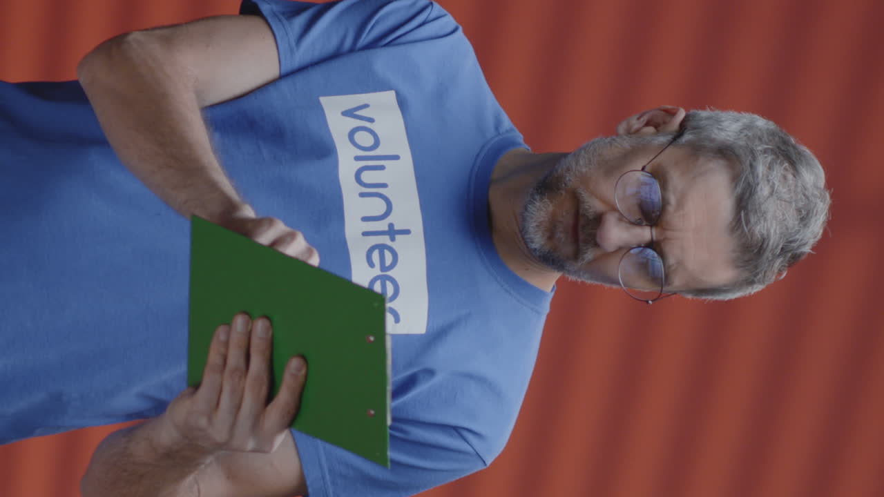 Man in Volunteer T-Shirt with Clipboard