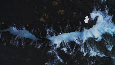 drone top down along glacier waterfalls and turquoise ice colored stream between mountains