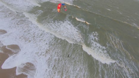 kitesurfer jumping and a drone flying above and around the kite