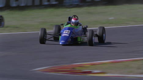 two racing cars race around a track