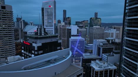 Aerial-shot-flying-between-skyscrapers,-camera-flying-towards-two-construction-cranes-in-the-middle-of-the-City