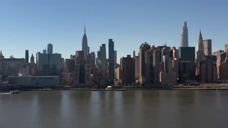 An-aerial-view-over-a-calm-East-River-on-a-sunny-day-with-blue-skies