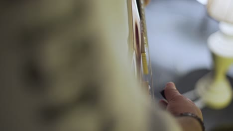 a man playing on an electric guitar in the theatre static shot, close up shot, insert shot, high angle shot