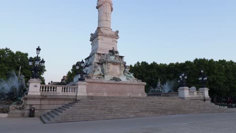 stairs at the bottom of the girondains monument in bordeaux with nobody during sunrise in the city