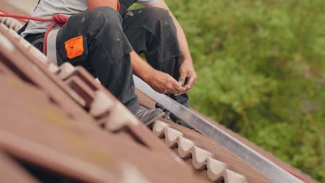 roofer installing metal railings for solar panel mounting