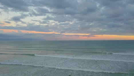 Aerial-flying-over-ocean-at-sunset-in-Muizenberg-South-Africa