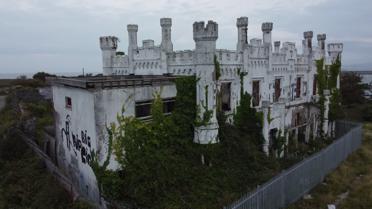 Soldiers point house aerial view rising over abandoned coastal Holyhead Victorian castle mansion