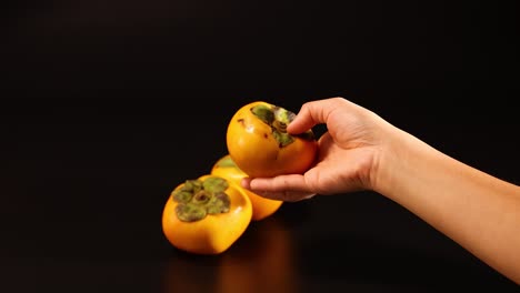 hands interacting with dragon fruit on table