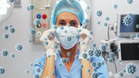 Animation-of-caucasian-female-doctor-with-face-mask-over-virus-cells