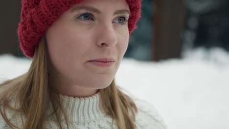 close up of woman standing outdoors and drinking hot tea in winter outdoor