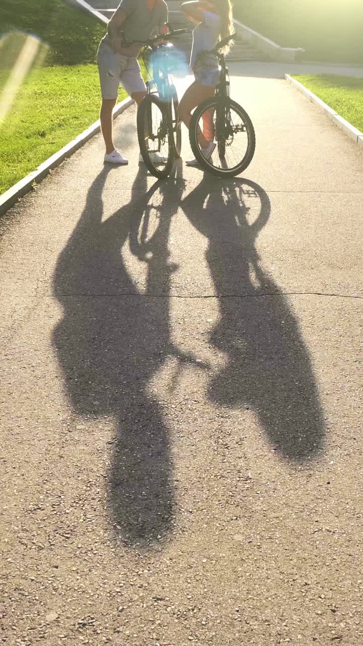 Couple Cycling in Park at Sunset