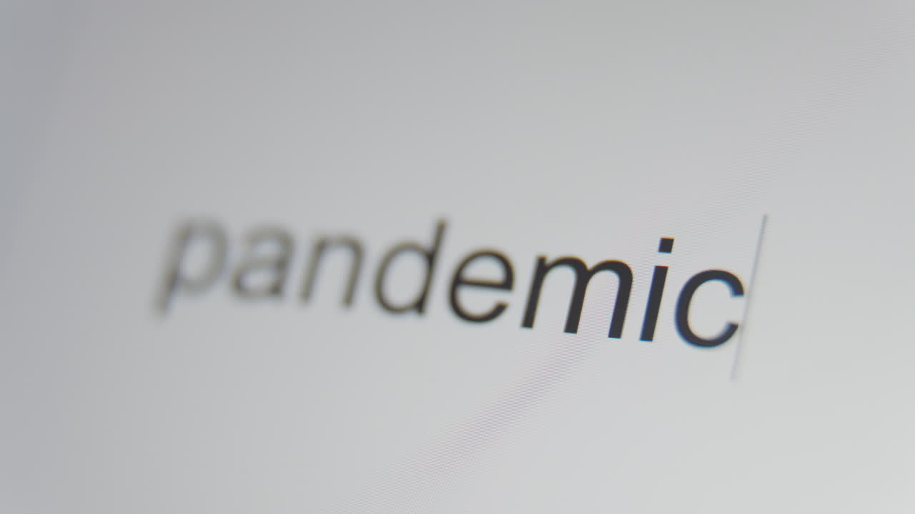 A close up of a digital screen showing a text cursor and "pandemic" being typed