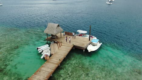 imágenes de drones de un pequeño embarcadero de madera, dando servicio a pequeñas lanchas rápidas en la laguna bora bora tahití