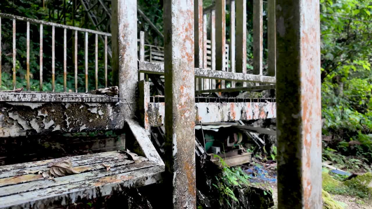 A view of dilapidated metal stairs with rust and weathering in an outdoor setting showcasing decay and neglect