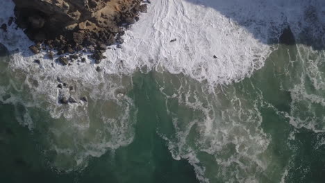 Drone-top-shot-of-sea-water-with-corals-hits-by-the-waves