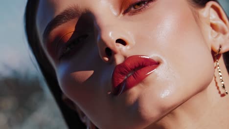 close-up portrait of a woman with bold makeup and red lips